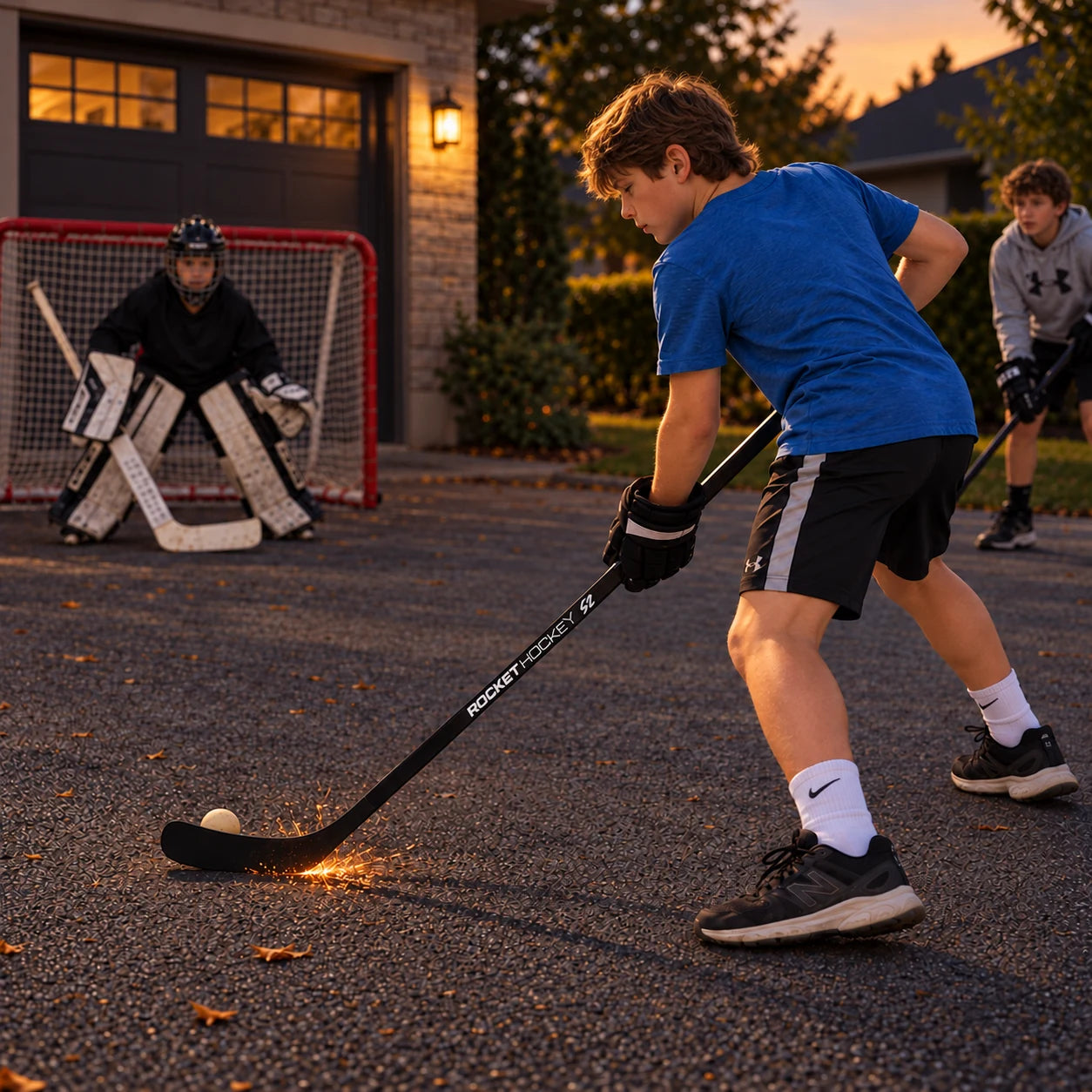 Three children enjoying street hockey together with a Rocket Hockey Spark Stick on a driveway